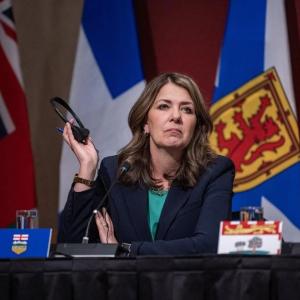 Alberta premier defends charging most Albertans for COVID-19 vaccines