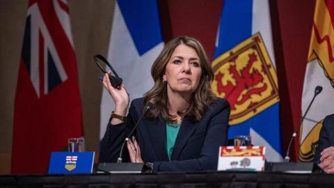 Alberta premier defends charging most Albertans for COVID-19 vaccines