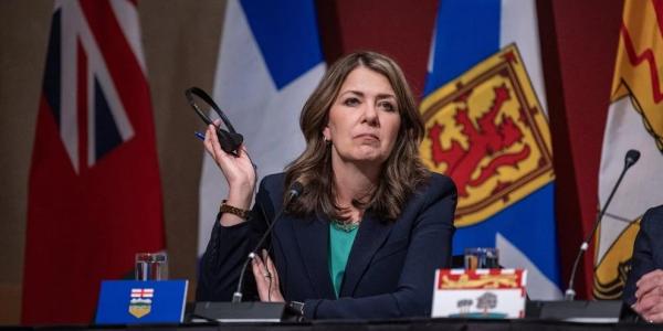 Alberta premier defends charging most Albertans for COVID-19 vaccines